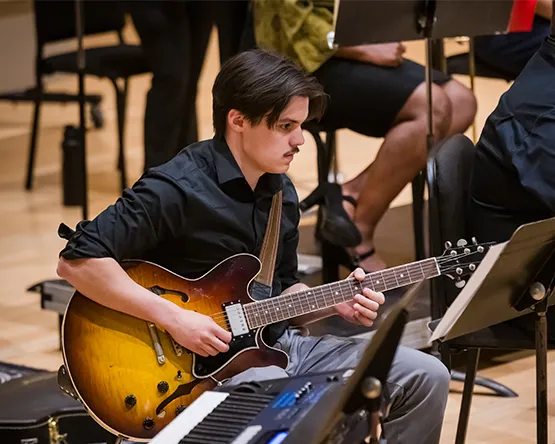 Music student playing guitar